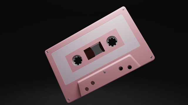 孤立在黑色背景上的淡粉色盒式磁带。视频素材