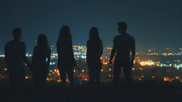 这五个人站在夜晚的城市背景上视频素材