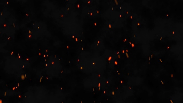 燃烧的篝火火花的特写镜头。火粒子在黑色背景与烟雾。从火中飞出余烬视频素材