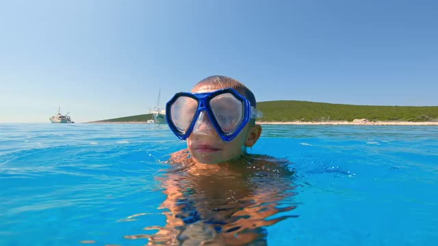小男孩戴着潜水面罩在水下游泳视频素材