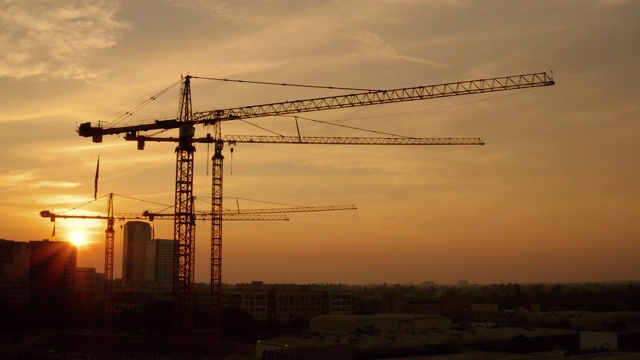 建筑工地-日落时起重机的鸟瞰图视频素材