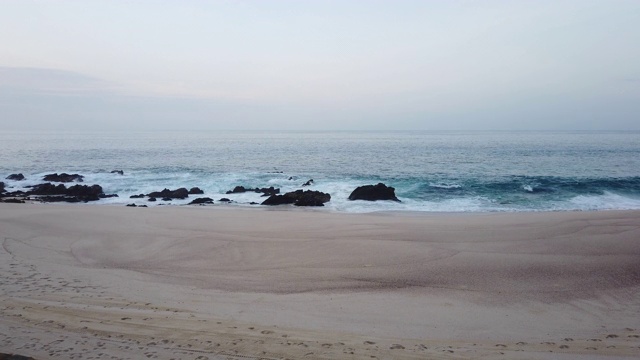 日出时海浪拍打海岸的景象视频下载