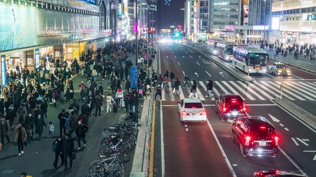 在日本东京新宿，一群人走在街道上，车流滚滚视频素材
