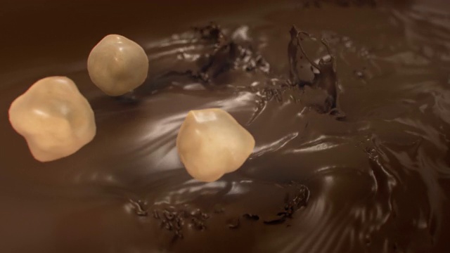 4K超级慢动作，榛子溅入液态牛奶巧克力视频素材