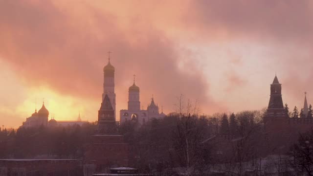 俄罗斯的冬天。全景拍摄。俄罗斯，莫斯科，在护城河上的最神圣的Theotokos代祷大教堂，在一个雪夜的日落克里姆林宫。在暴风雪天气中的瓦西里大教堂视频素材