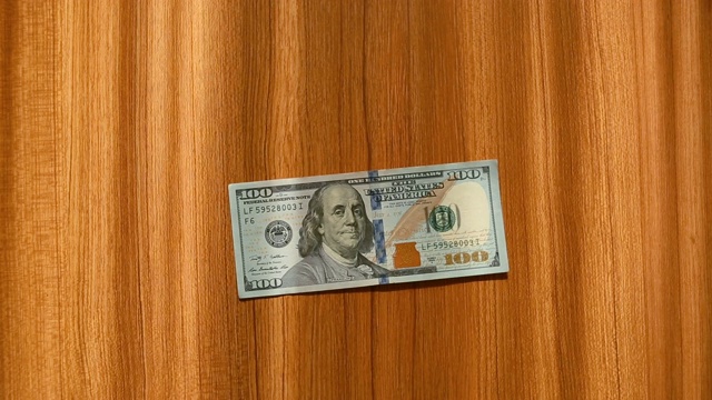 实录:一张百元美钞掉在木桌上视频素材