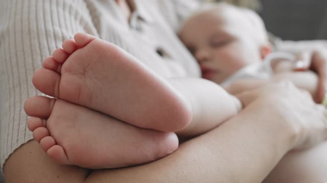 可爱的婴儿睡在妈妈的手里视频素材