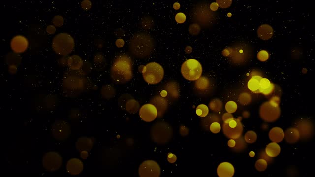 金色颗粒抽象背景与闪耀的金色浮动尘埃颗粒耀斑散焦星在黑色背景。未来在太空中闪闪发光。视频素材