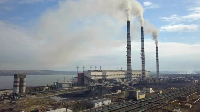 鸟瞰图的高烟囱管道与灰色烟雾从煤电厂。用化石燃料发电。视频素材