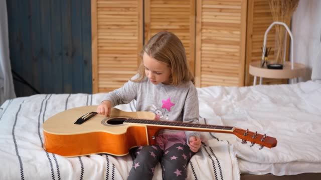小女孩在家弹原声吉他视频素材
