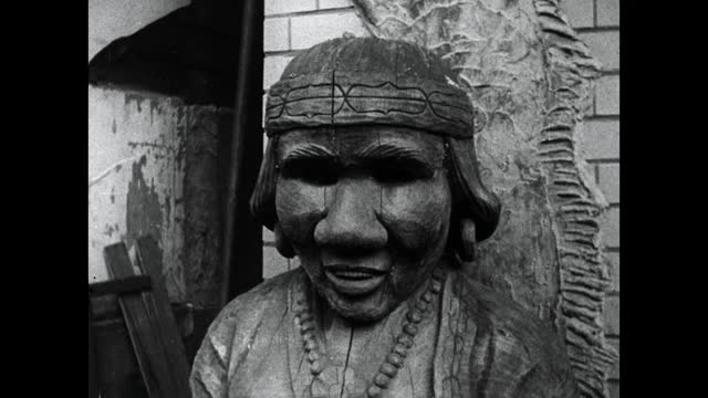 雕刻的阿伊努妇女为一只熊哺乳雕像;1964视频下载