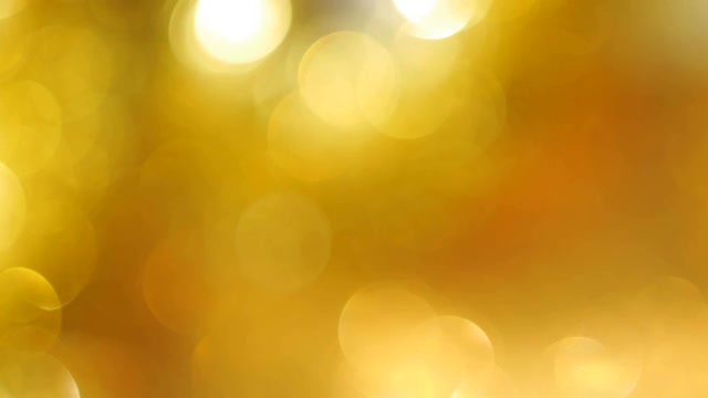 散焦明亮的金色闪烁灯创建柔和的散焦圈作为背景视频下载