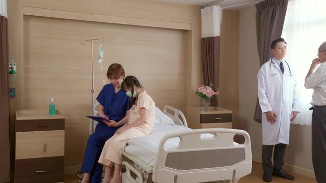 4K超高清多莉右:医生在医院病房探望小女孩病人，并向父母解释症状。医院保健理念。视频下载