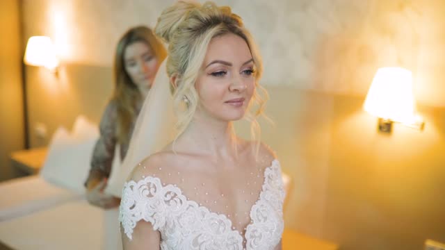 年轻的新娘在婚礼礼服与她的伴娘直面纱视频下载
