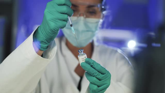 在实验室工作的女性研究员:冠状病毒和冠状病毒疫苗视频素材