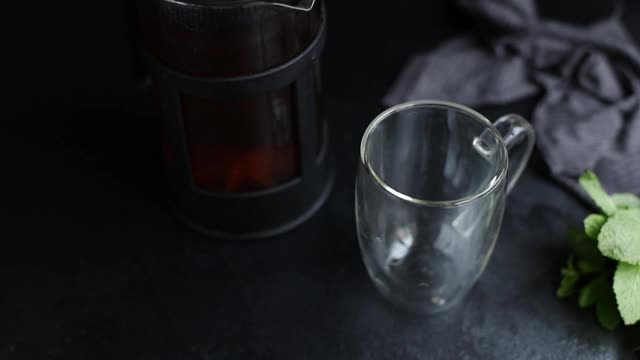 热茶新鲜倒透明杯与双层底透明茶壶准备煮和吃的桌子上，为使健康餐小吃俯视图复制空间为文字食物背景质朴视频素材
