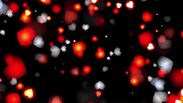 摘要发光的红心和白心粒子漂浮在黑色背景无缝循环动画。4K 3D无尽的视觉特效爱视频艺术，母亲节，婚姻，情人节，结婚纪念日。视频下载
