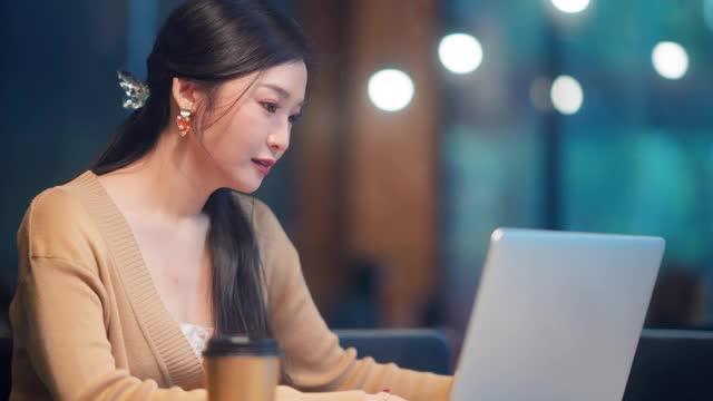 美丽的亚洲女人在休闲服装使用笔记本电脑工作电话视频会议视频下载