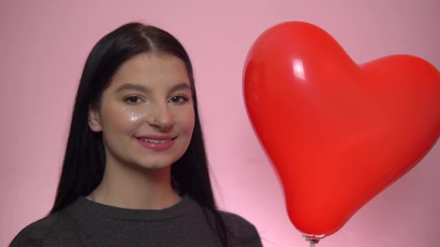 微笑女人气球心，圣瓦伦丁节概念，浪漫的节日视频素材