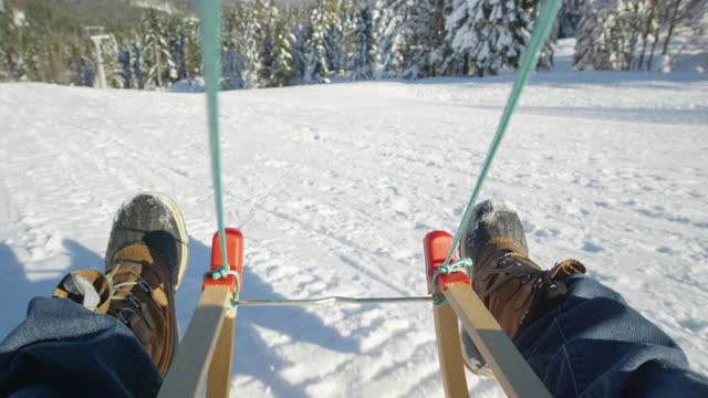 视频:在阳光明媚的Kranjska Gora山上，滑雪橇在白雪覆盖的草地上。视频素材