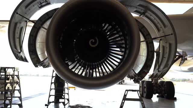 在商用飞机的涡轮发动机上工作的飞机机械学。视频素材