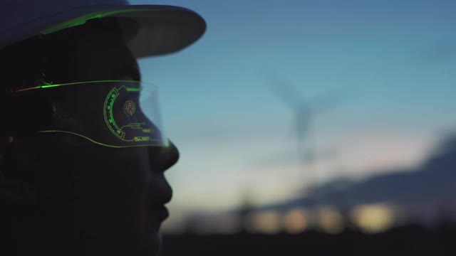 未来女工程师戴着虚拟现实眼镜在风力涡轮机农场。视频素材