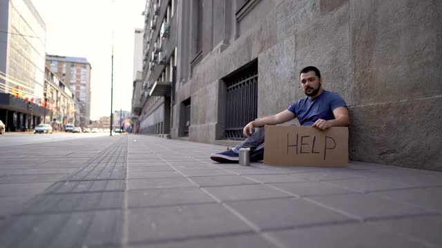 无家可归的人坐着乞求帮助视频下载