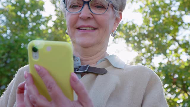 在户外使用手机的资深女性视频下载