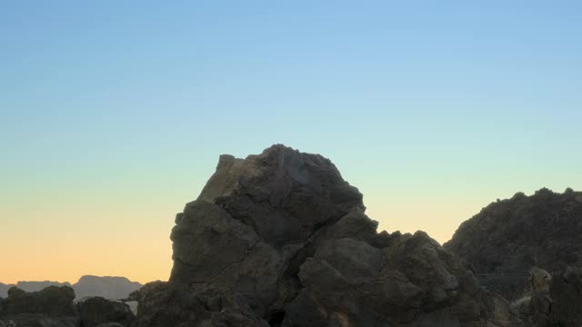 一个男人爬上一座山峰，得意地向天空举起双手视频素材