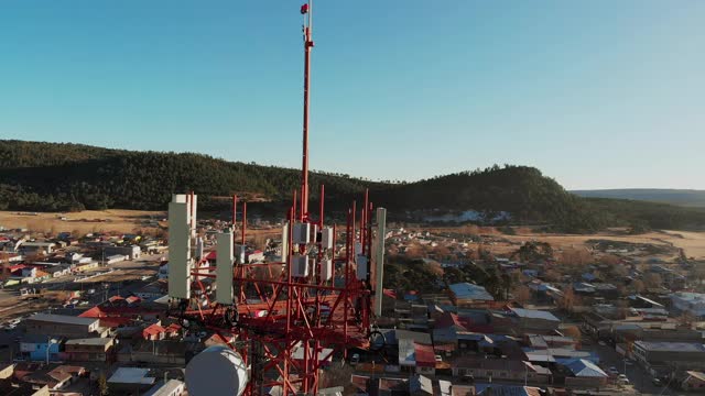 一个通信基站塔在圣胡安尼托，奇瓦瓦，墨西哥，在Sierra Madres，山城，镇下面，无人机视频剪辑视频素材