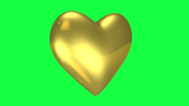 旋转的金色心形在绿色的背景上视频素材