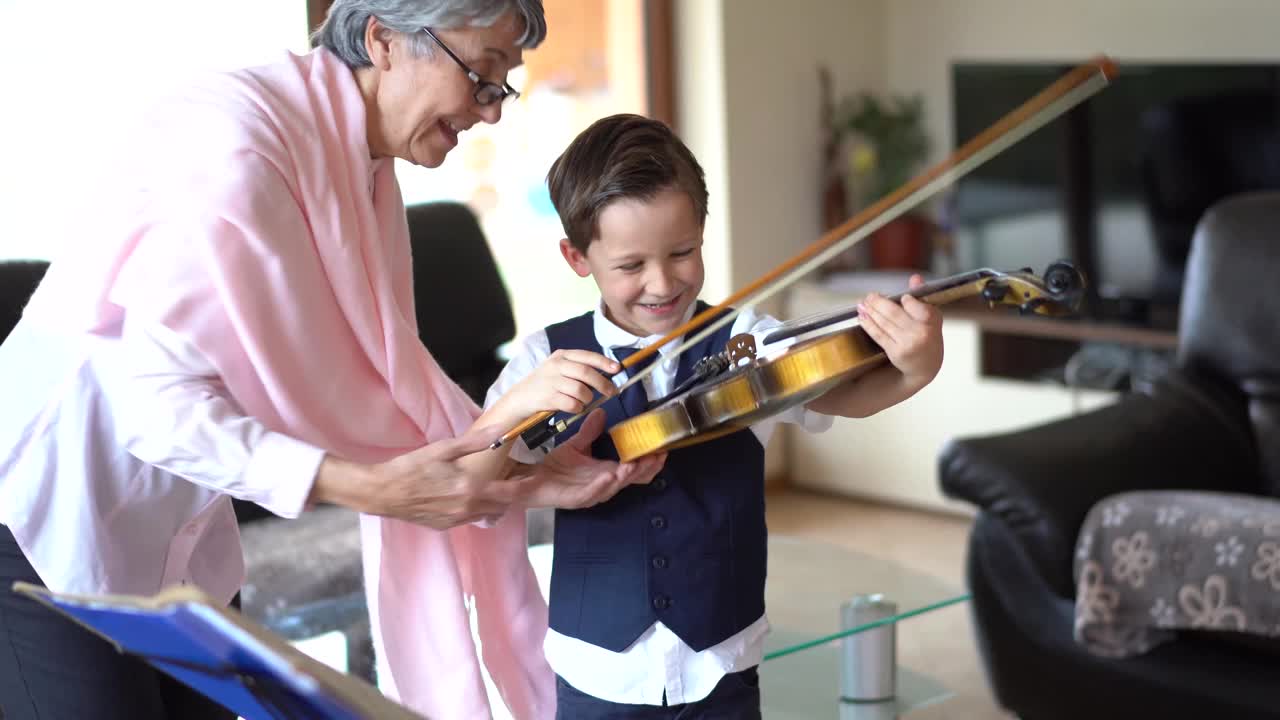 高级小提琴老师教一个小男孩拉小提琴视频素材