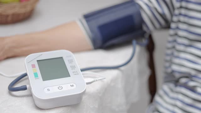 特写老年妇女在家测量血压视频下载