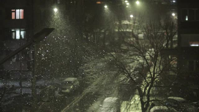 美丽的冬季景观与飘落的雪。城市的冬夜视频素材