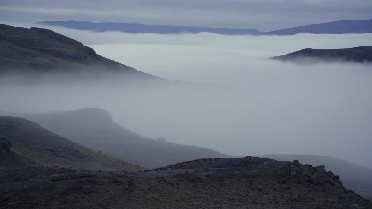 云雾缭绕的小山和一只秃鹰飞过白雪覆盖的山峰视频下载