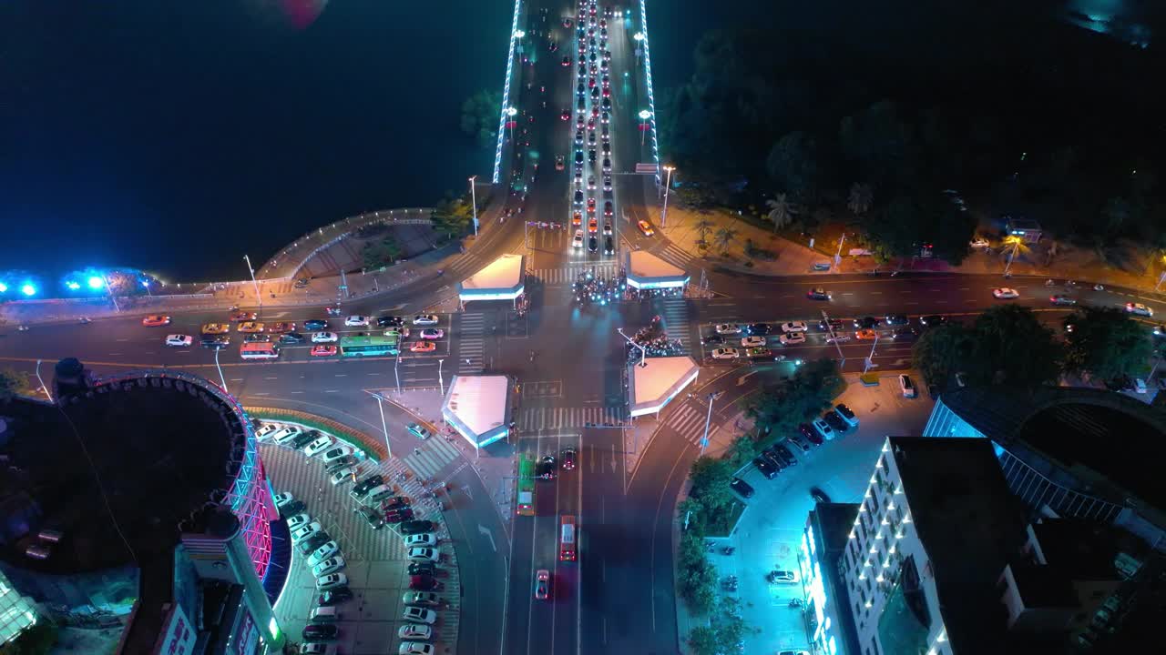 夜间照明海南岛三亚市交通十字路口河边高空俯视图4k中国视频素材