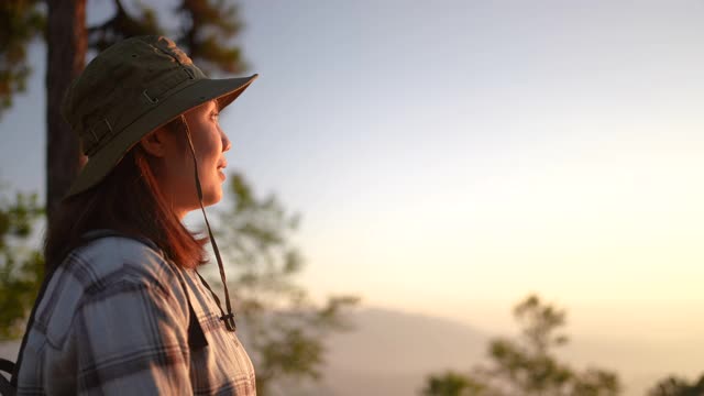 女旅行者用智能手机在山上拍摄日落美景视频素材