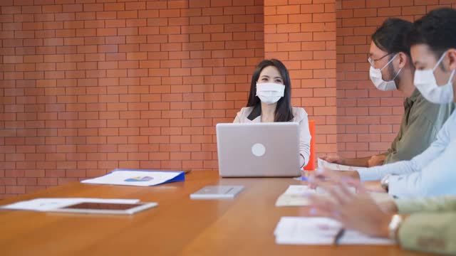 新冠肺炎疫情爆发后，亚洲商界人士佩戴防护口罩。为避免感染冠状病毒，男女不握手，不握手，不碰肘。视频素材