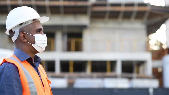 在工地上工作的男人们，用冠状病毒防护口罩迎接新一代视频下载