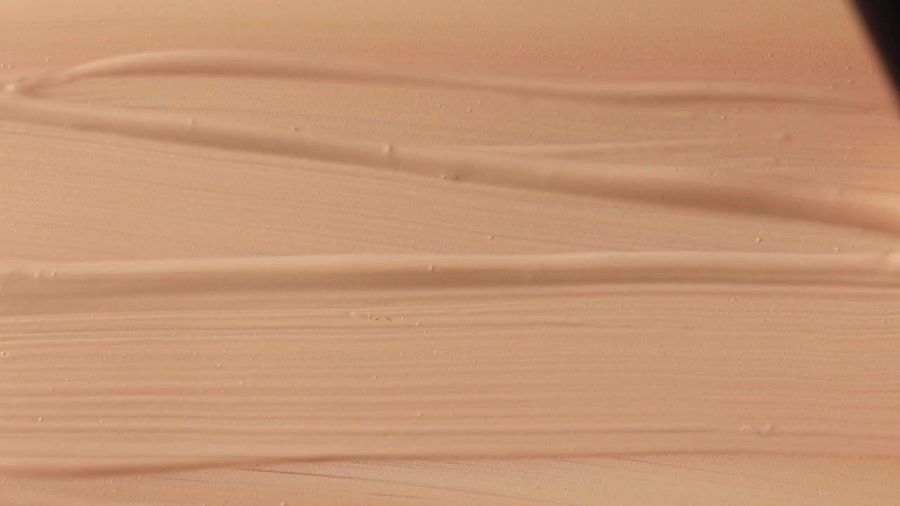 米色粉底霜背景近距离涂抹，用刷子，美丽的粉彩纹理，化妆产品视频下载