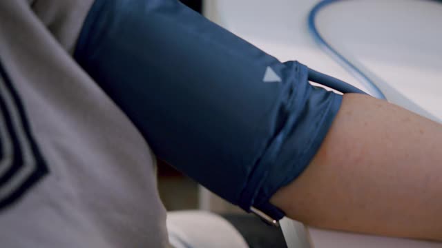 老年妇女在家用医疗器械手检查血压和心率。视频素材