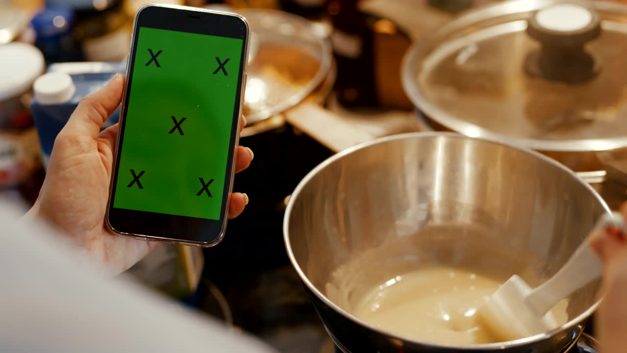 厨师在厨房使用手机和双层蒸锅制作酱汁视频下载