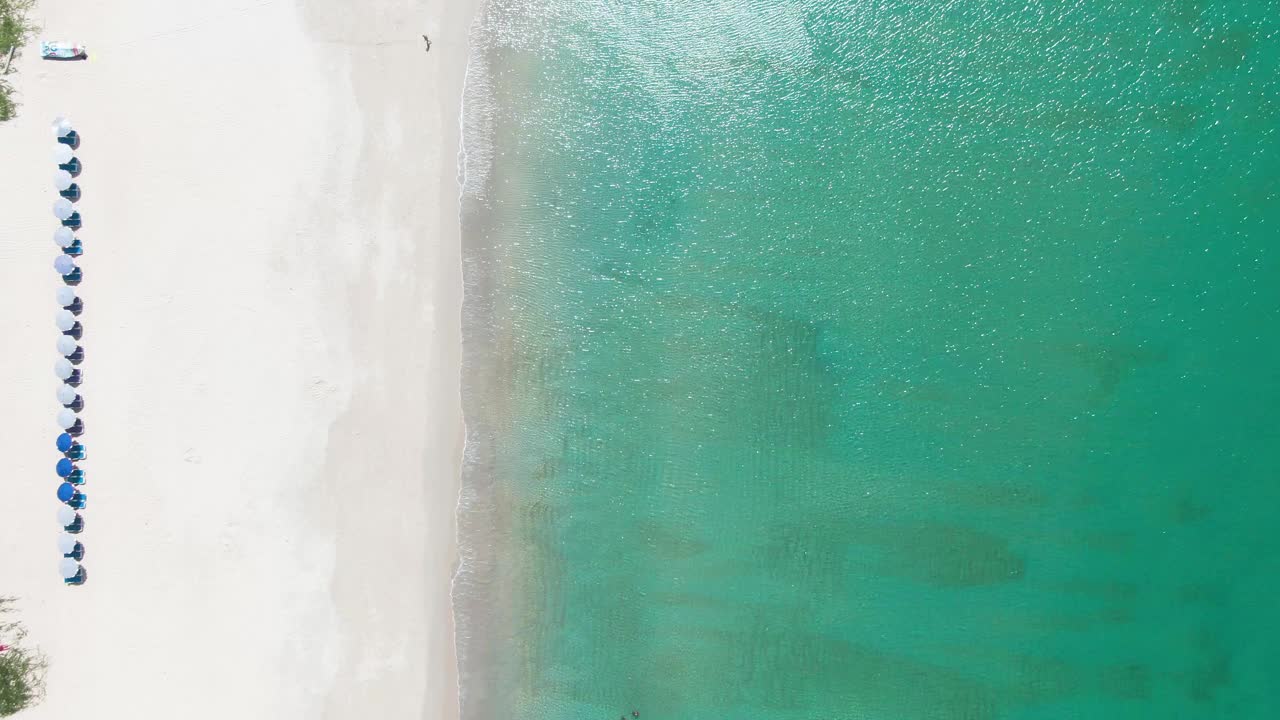 美丽的白色沙滩与雨伞在晴朗的日子，奈汉海滩，普吉岛，泰国。视频素材