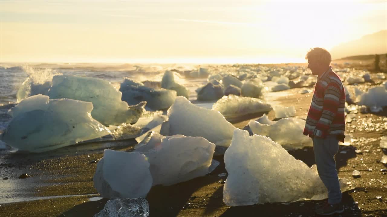 在欧洲的冰岛，日落时满是冰山的钻石海滩上，人们在散步。视频素材