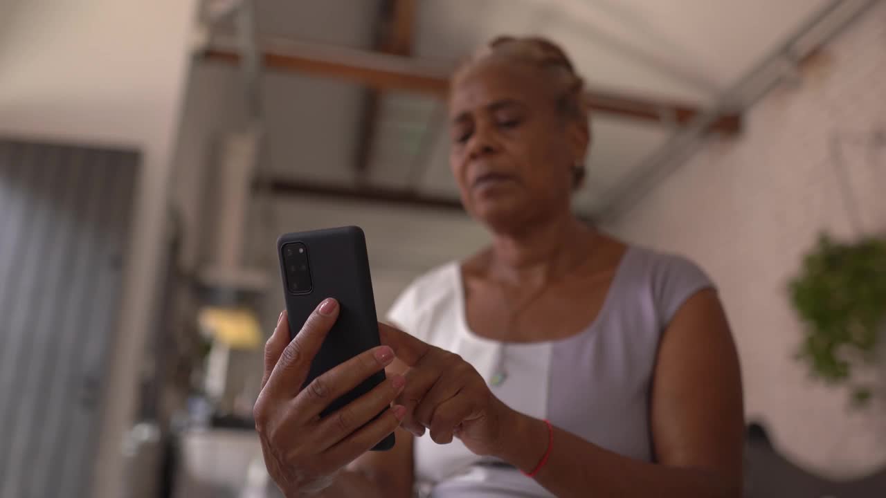 在家里使用智能手机的成熟女性视频素材