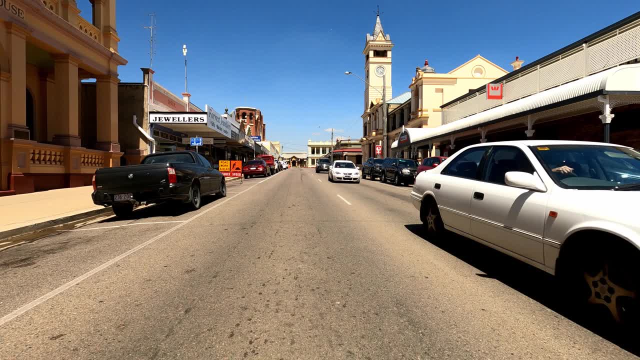 驾驶通过繁忙的乡村小镇主要街道在阳光明媚的一天，澳大利亚农村视频下载