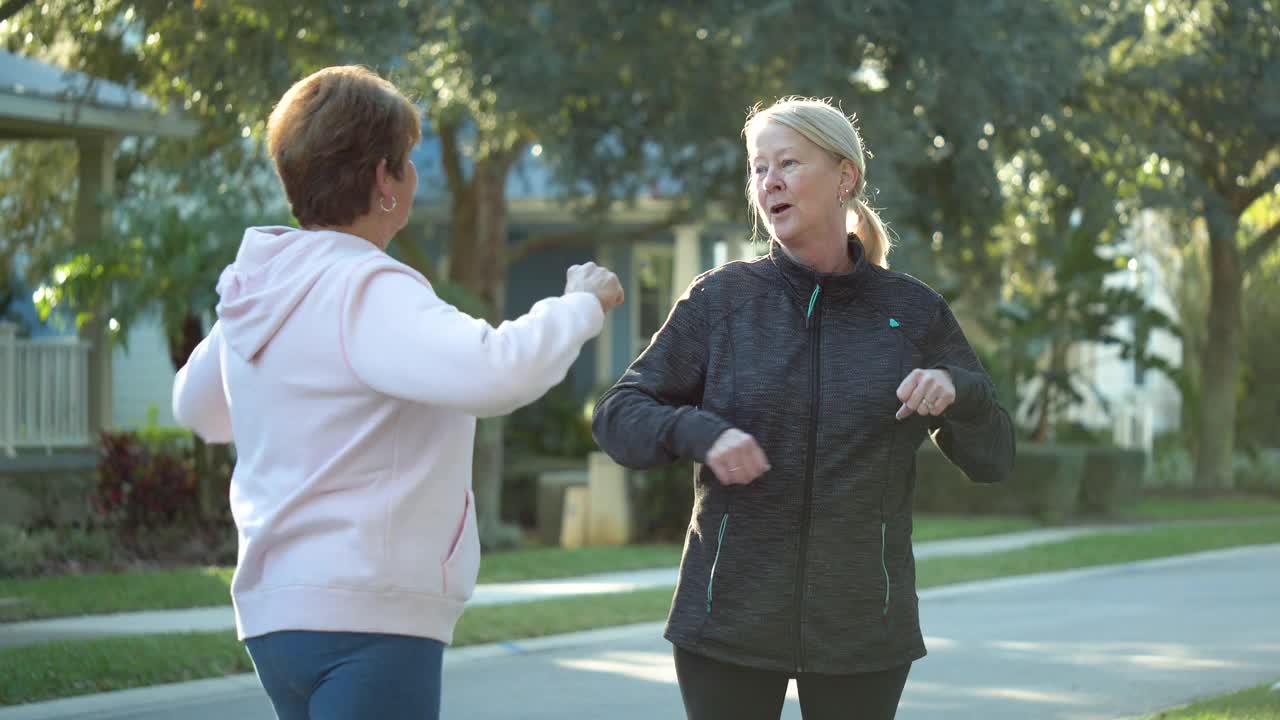 两个老年妇女在车道上锻炼时聊天视频下载