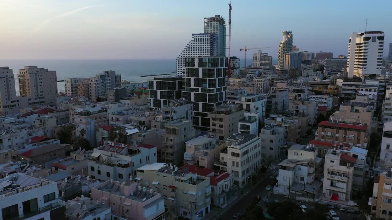 航拍的城市景观在日落的天空，无人机上升在城市-特拉维夫，以色列视频素材