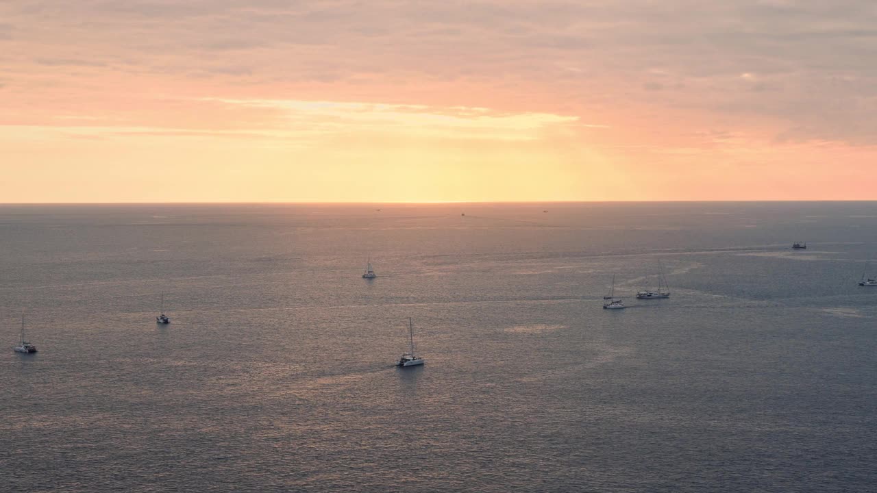 平静的海面与日落的天空和太阳透过云与游船与游客视频素材