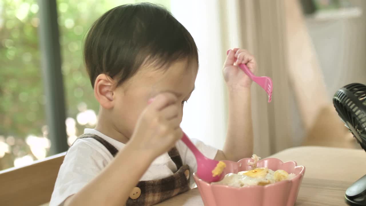 亚洲小男孩独自吃饭视频素材